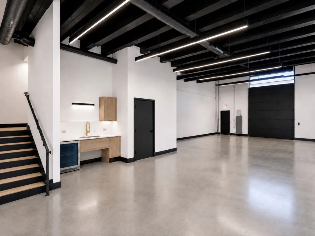 Suite ground floor with polished concrete, a kitchenette, a stair to the second floor and an overhead door